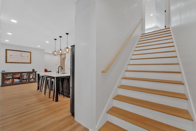 1936 Turners Landing Rd, Russellville, TN 37860 - stairway with hardwood / wood-style floors, sink, and an inviting chandelier