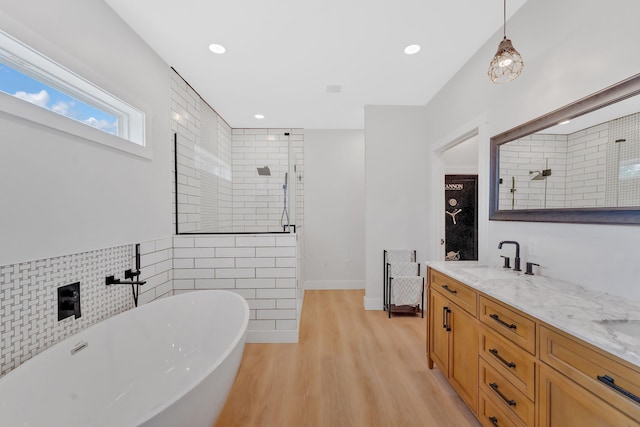 1936 Turners Landing Rd, Russellville, TN 37860 - bathroom featuring hardwood / wood-style floors, vanity, tile walls, and independent shower and bath