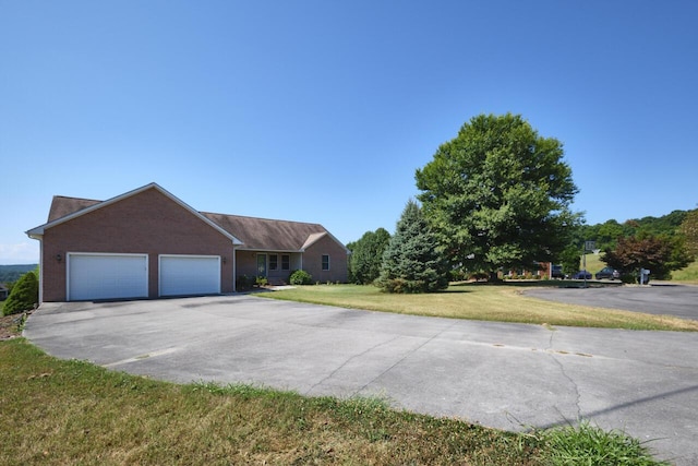 view of front of home featuring a garage and a front lawn