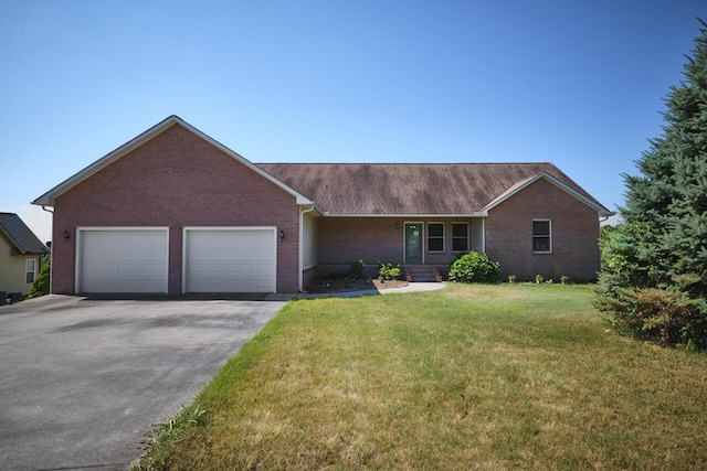 ranch-style house featuring a front yard and a garage