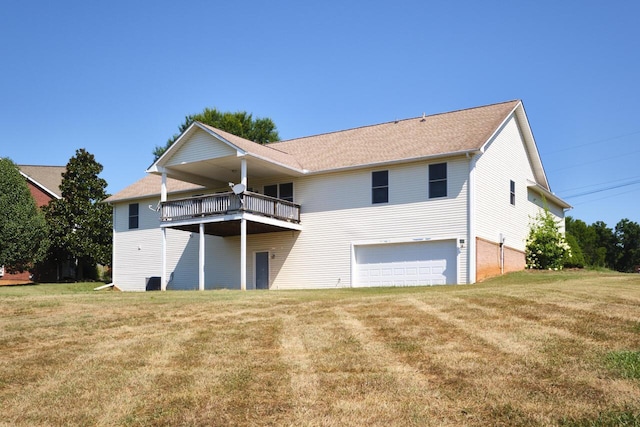 back of property featuring a lawn, a balcony, and a garage