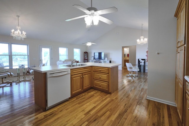 kitchen featuring hardwood / wood-style floors, dishwasher, ceiling fan with notable chandelier, hanging light fixtures, and sink