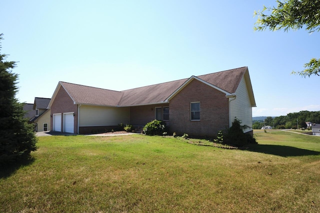 exterior space with a garage and a lawn