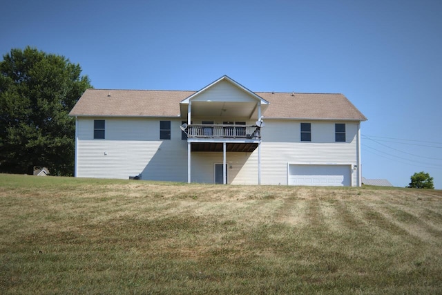 back of property with a lawn and a garage