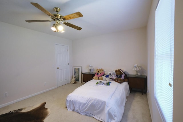 bedroom featuring ceiling fan and light colored carpet