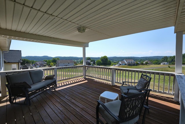 deck with outdoor lounge area and a mountain view