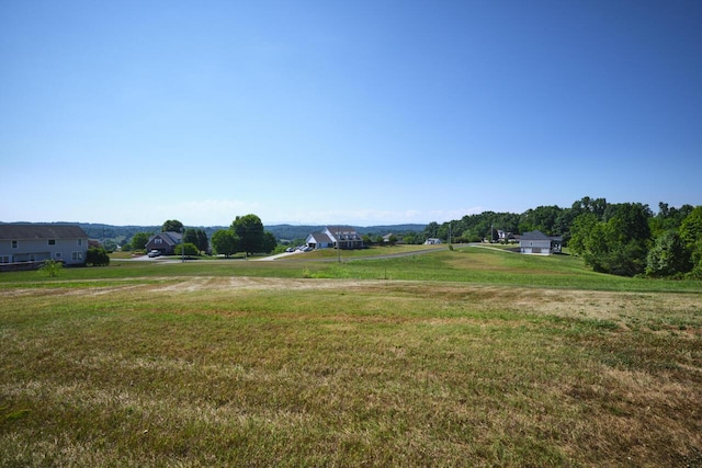 view of home's community with a yard and a rural view