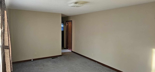 unfurnished room featuring carpet