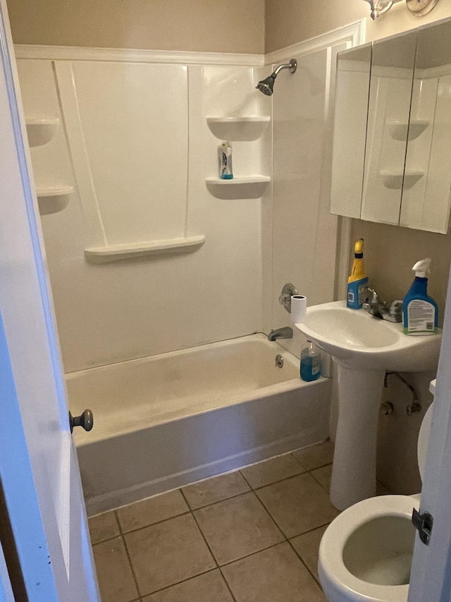 bathroom with toilet, tile patterned floors, and shower / bathtub combination