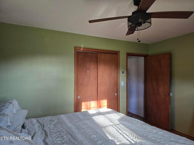 bedroom featuring ceiling fan and a closet