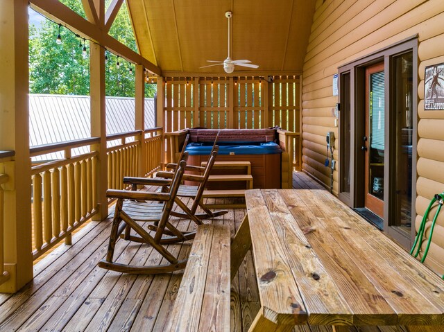 sunroom / solarium with ceiling fan, a hot tub, and vaulted ceiling