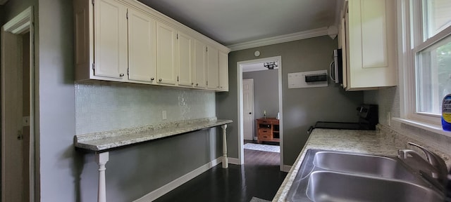 1034 E Skyline Dr, Morristown, TN 37813 - kitchen featuring ornamental molding, tasteful backsplash, stainless steel microwave, white cabinets, and light countertops