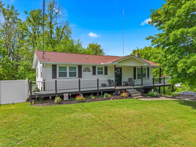 view of front of property with a porch, roof with shingles, a chimney, and a front yard