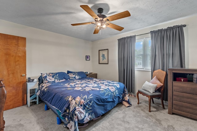 bedroom featuring ceiling fan and carpet