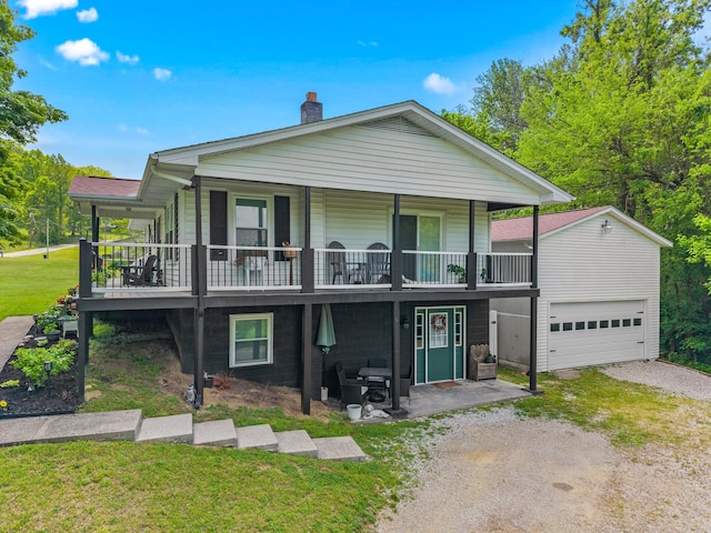 view of front of house with a chimney, driveway, and a front yard