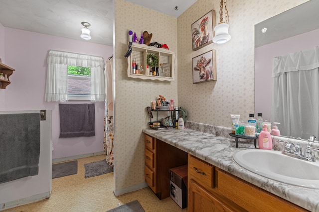 full bath with vanity, wallpapered walls, and curtained shower