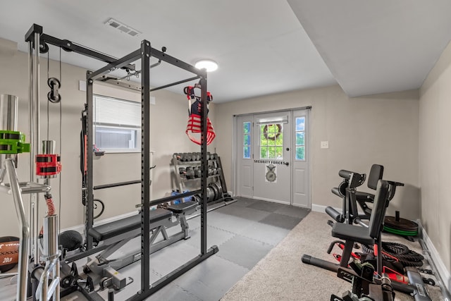 exercise area featuring baseboards and visible vents