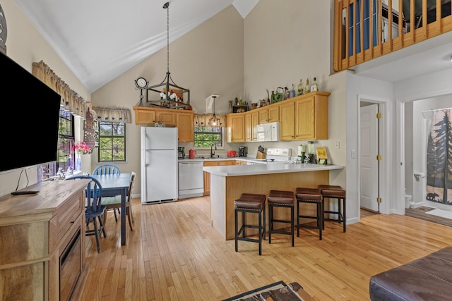 5014 Latta Way, Gatlinburg, TN 37738 - kitchen featuring a peninsula, white appliances, high vaulted ceiling, and light wood-style floors