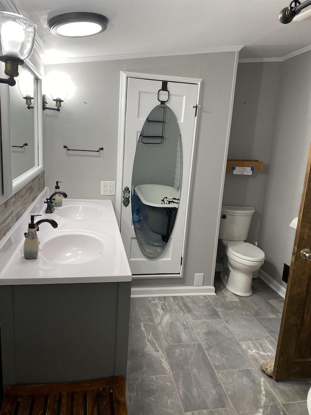 bathroom featuring vanity, toilet, and ornamental molding