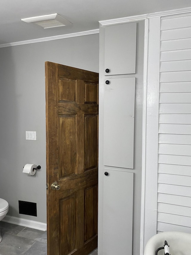 bathroom featuring toilet and ornamental molding