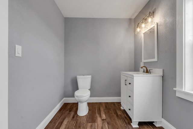 bathroom featuring hardwood / wood-style flooring, vanity, and toilet