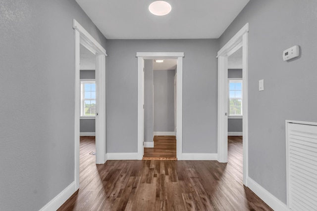 corridor featuring dark wood-type flooring