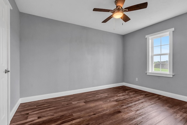 empty room with dark hardwood / wood-style floors and ceiling fan