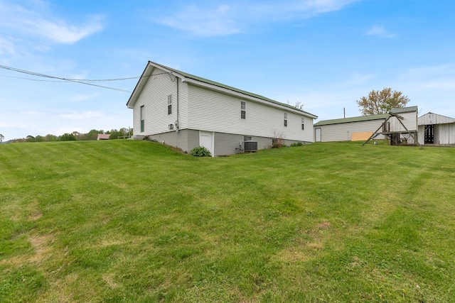 rear view of house with a yard and cooling unit