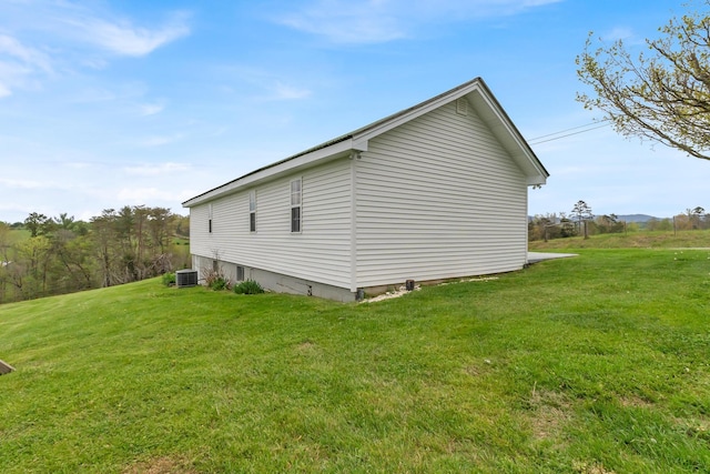 view of side of property with a lawn