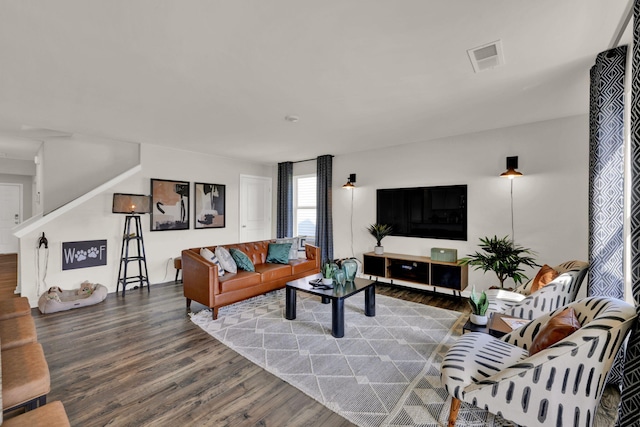 living area with wood finished floors and visible vents