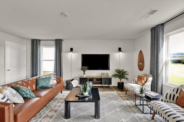 living room with visible vents and wood finished floors