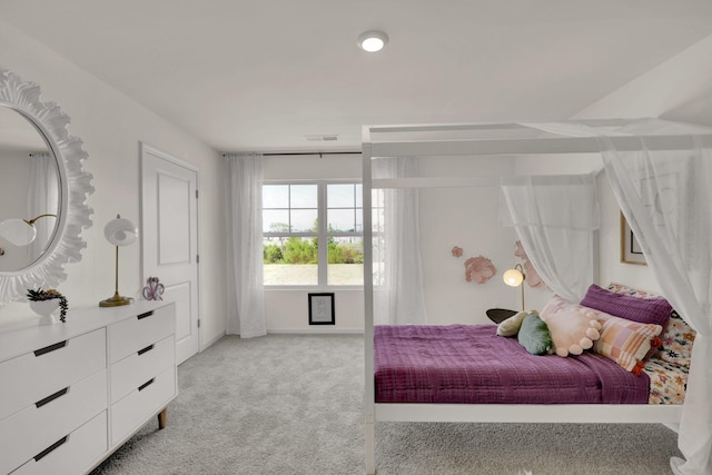 bedroom with light carpet and baseboards