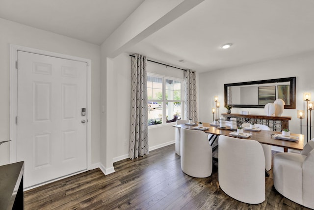 dining area with baseboards and dark wood-style flooring