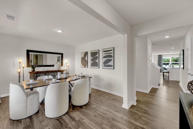 dining area with baseboards, visible vents, wood finished floors, and recessed lighting