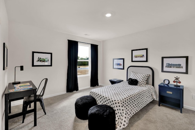 carpeted bedroom featuring baseboards