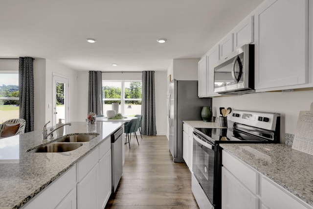 kitchen with white cabinets, stainless steel appliances, and a sink