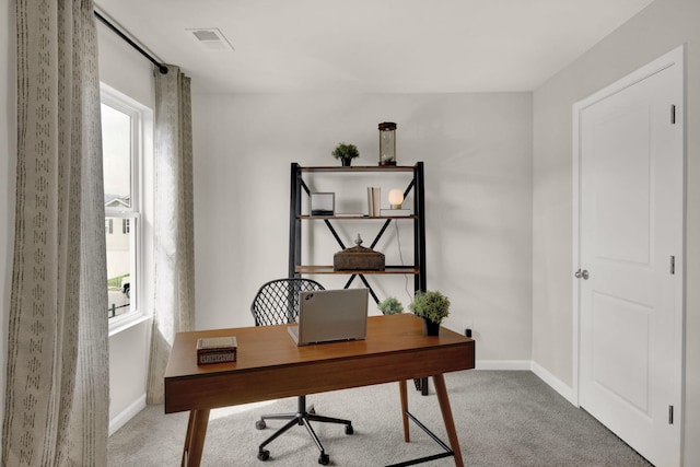 carpeted office with baseboards and visible vents