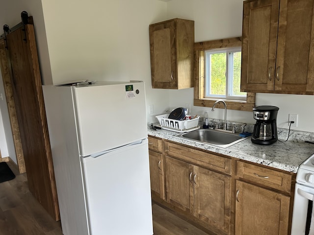 1101 Beason Ridge Rd, New Tazewell, TN 37825 - kitchen with white appliances, dark wood-type flooring, light countertops, and brown cabinets