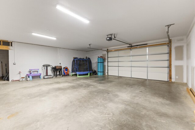 garage with a trampoline and a garage door opener