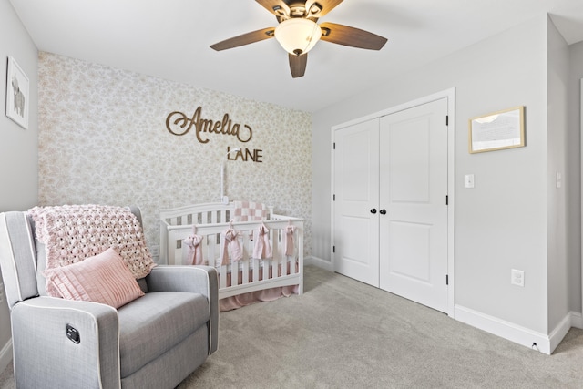 bedroom featuring a closet, carpet flooring, baseboards, and ceiling fan