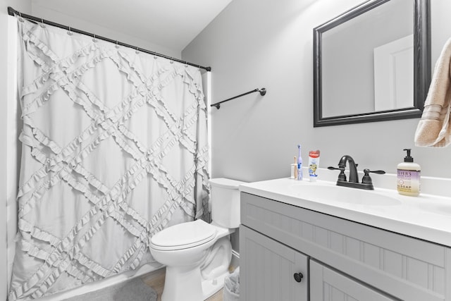 full bathroom with vanity, a shower with shower curtain, and toilet