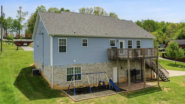 rear view of property with stairway, a yard, central air condition unit, a patio, and a deck