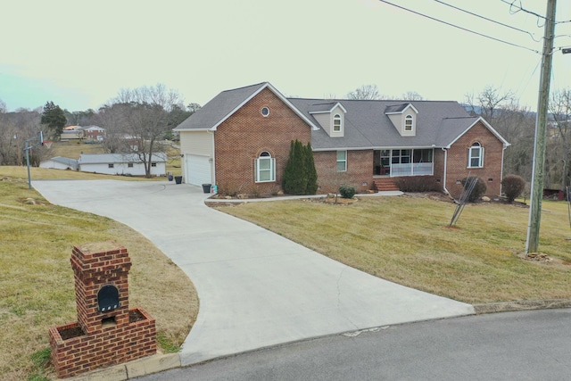 view of front of home with a garage, covered porch, and a front yard