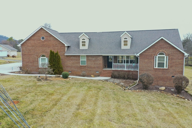 new england style home featuring a porch and a front yard