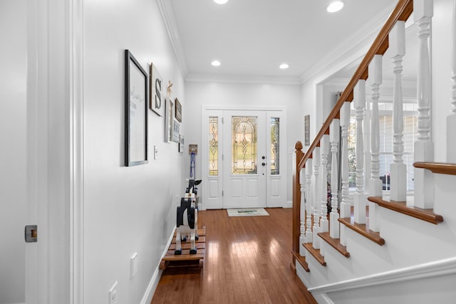 foyer featuring hardwood / wood-style floors and crown molding