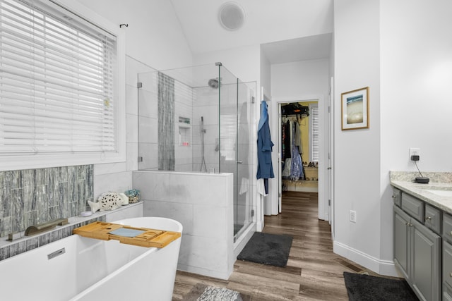 bathroom featuring vanity, separate shower and tub, and hardwood / wood-style floors