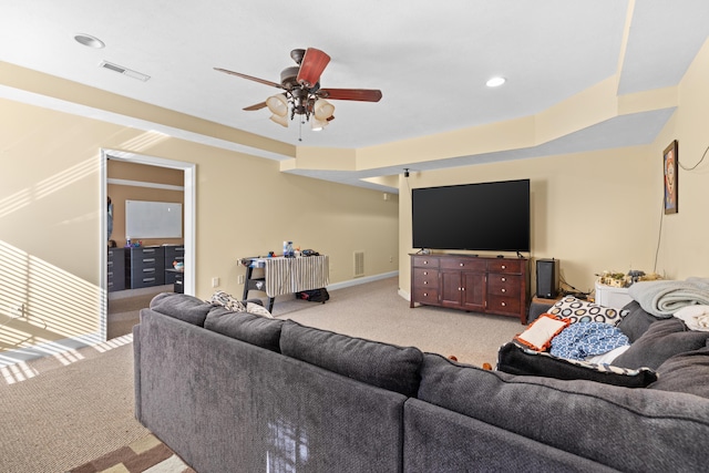 living room featuring light carpet and ceiling fan