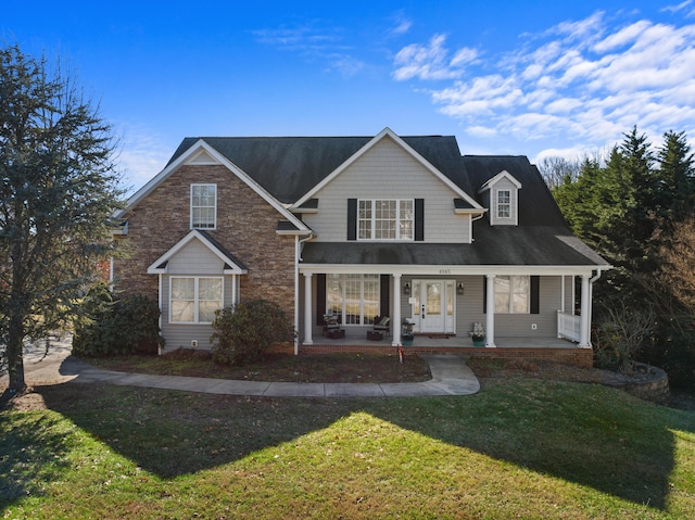 view of front property featuring covered porch and a front lawn