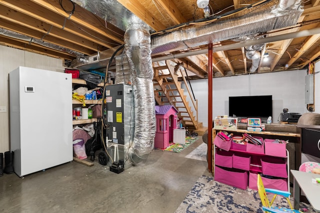 unfinished basement with freestanding refrigerator and stairway