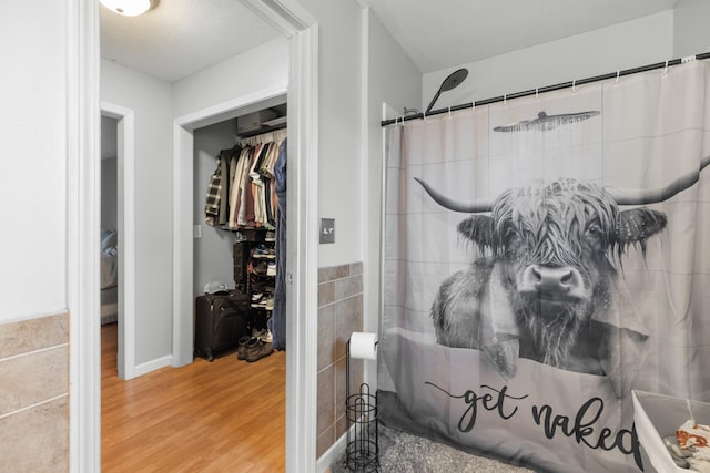 full bath featuring a shower with curtain and wood finished floors